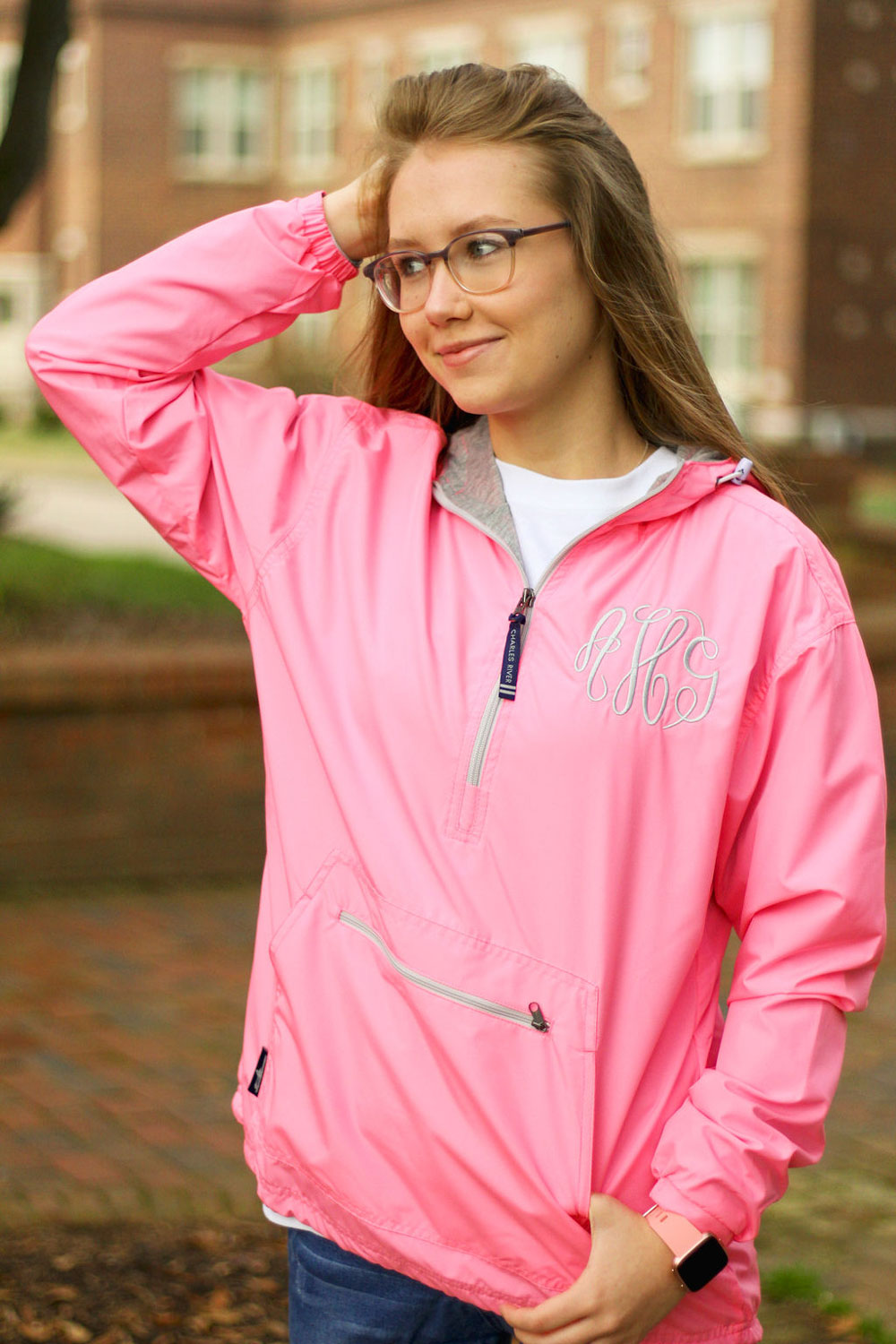 teenage girl wearing pink monogrammed rain jacket pullover from charles river