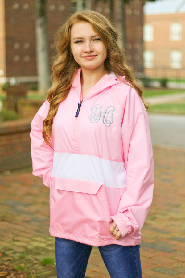 woman wearing pink with white stripe charles river pullover rain jacket